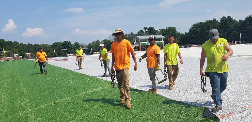 synthetic-turf-installation-crew-field-project.